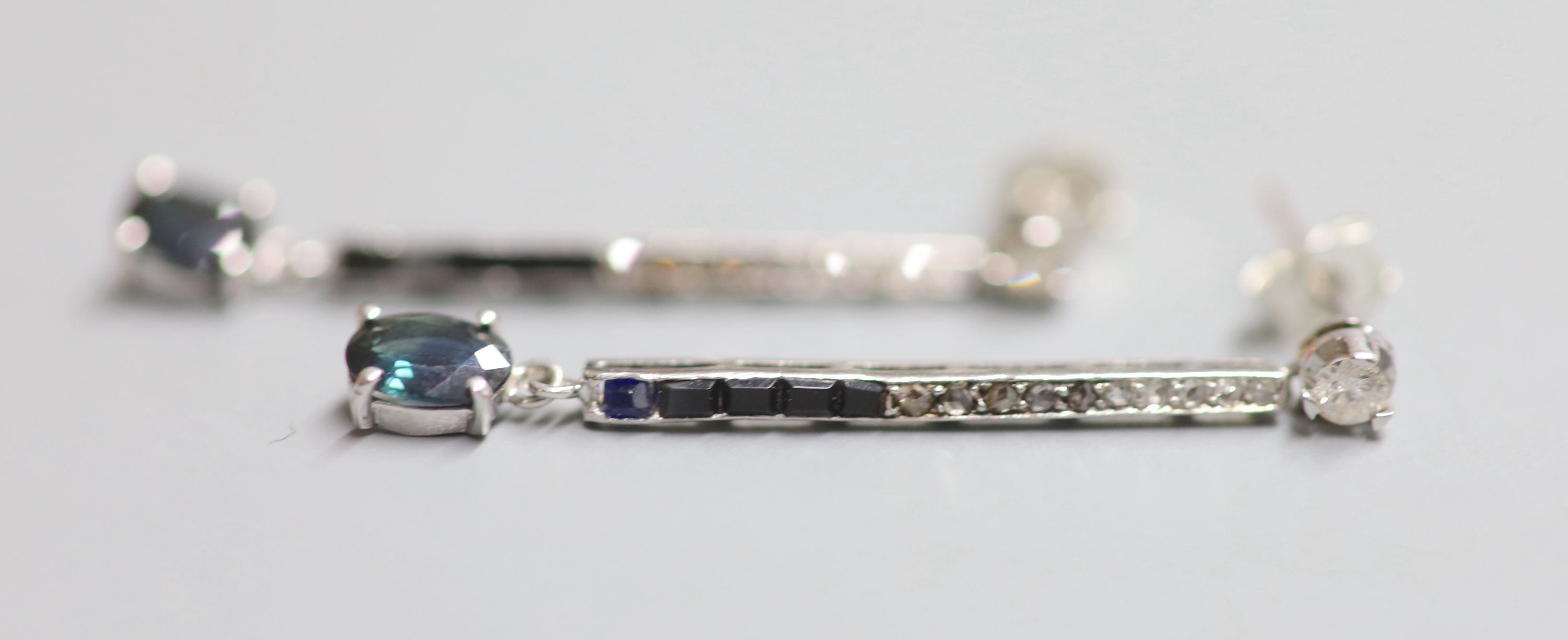 A pair of white metal, sapphire, black onyx, rose and round cut diamond set line drop earrings, 38mm, gross 3.6 grams.